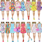 BJDBUS random assortment of handmade satin doll dresses with sticky buckle fasteners displayed openly