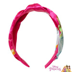 LUV HER brand pink hairband displayed to show the print quality of six different cartoon princesses.