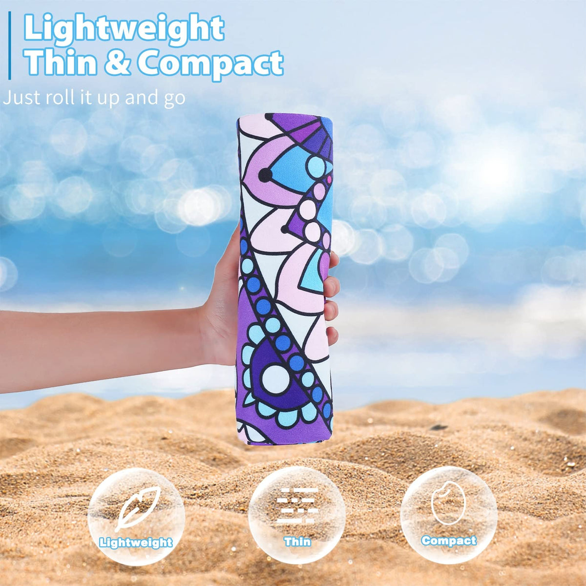 Oversized quick dry travel towel unfolded flat on a beach setting