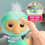 Fingerlings teal monkey toy with posable tail sitting on desk