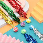 Close up shot of the vibrant multi colored rubber bouncing balls with flowy ribbons.
