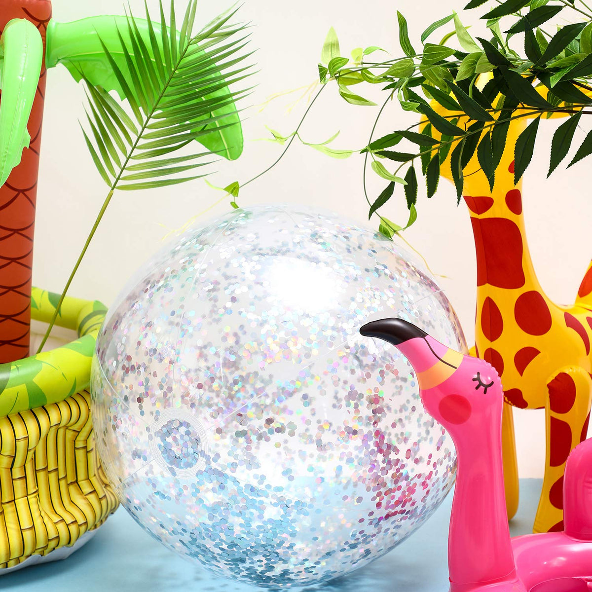 Compact deflated clear PVC plastic beach toy showcasing the interior metallic silver confetti.