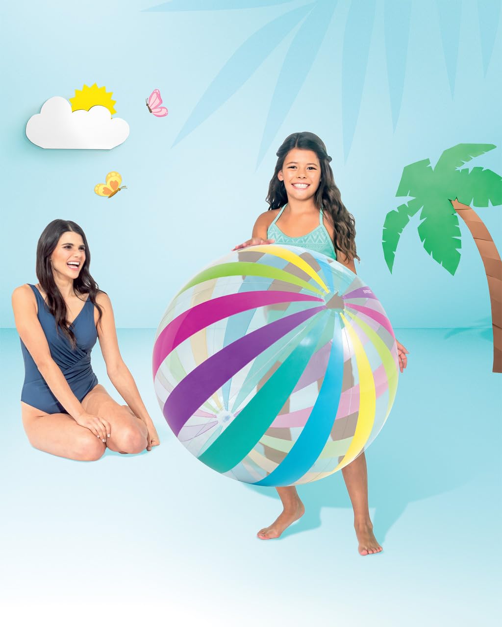 Intex giant colorful dot pattern ball being inflated with an air pump outdoors