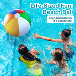 Three oversized inflatable rainbow beach balls arranged as summer party decorations