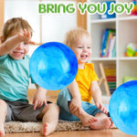 Two pieces of large sized inflatable sensory balls resting side by side on an outdoor grass lawn.