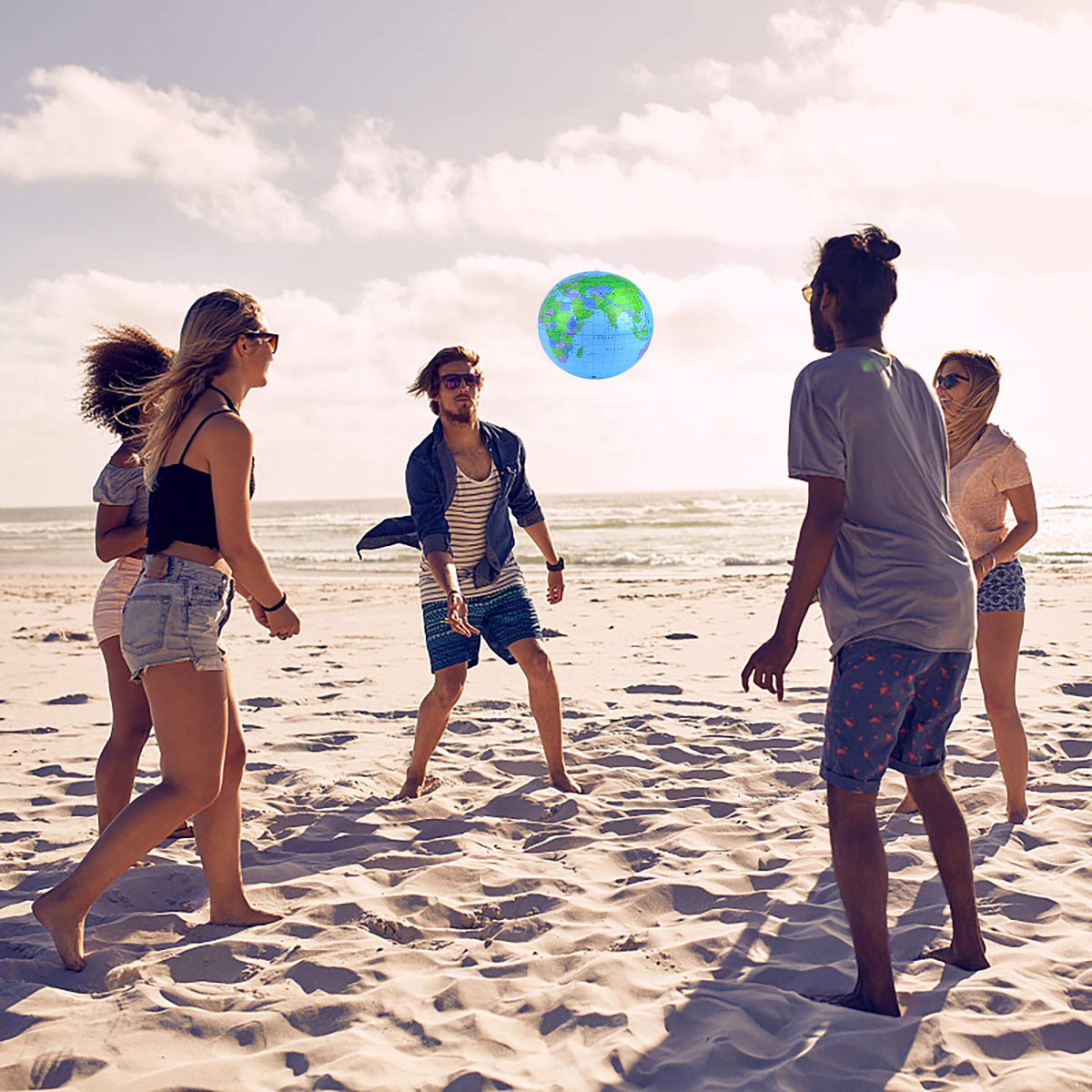 Coopay Inflatable World Globe being used as a vibrant decoration for an outdoor summer party.