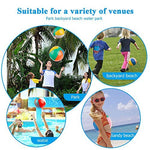 Children tossing lightweight classic rainbow beach spheres during an outdoor summer party.