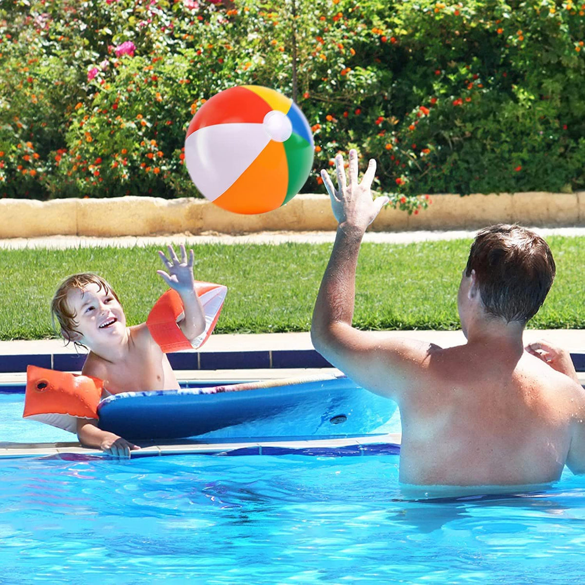 Children playing with lightweight multi color inflatable balls in an outdoor swimming pool.