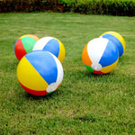 Deflated and folded rainbow beach balls illustrating compact storage convenience.