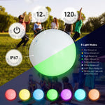 Inflatable twelve inch glow in the dark beach balls floating on water at night