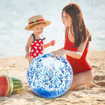 Close up view of the blue metallic glitter moving freely inside the clear PVC beach toy