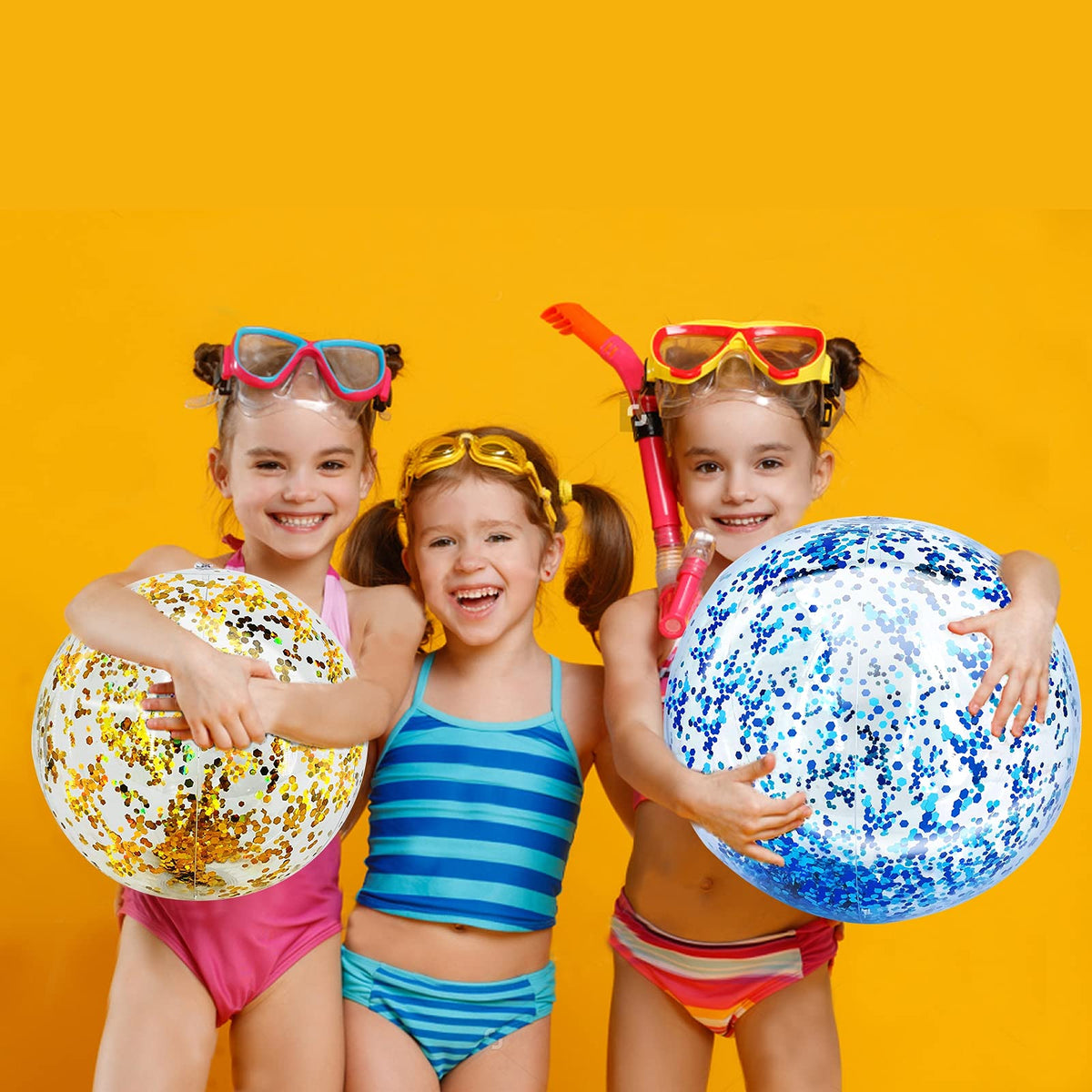 Adults and children tossing the jumbo sparkling clear pool balls during an outdoor summer party