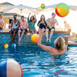 Close up view of the secure air pinch valve on a vibrant rainbow colored inflatable party favor.