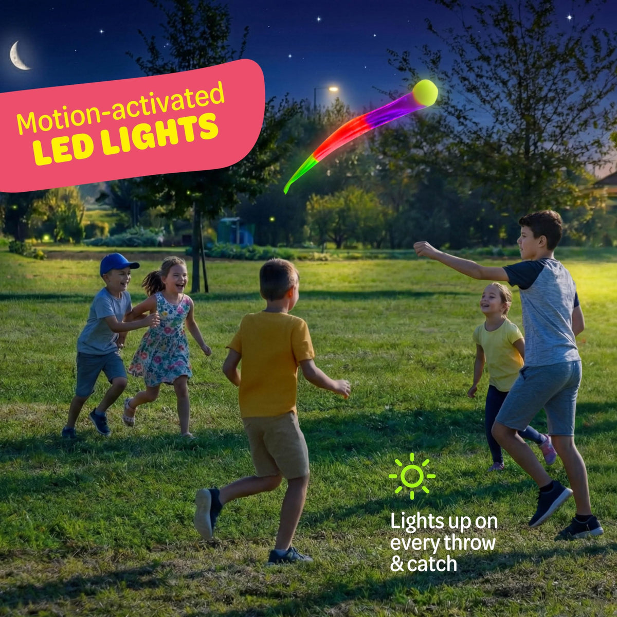 Motion activated LED ball glowing brightly in a dark backyard setting.