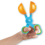 Close up of translucent Handy Scoopers showing scissor-style mechanism