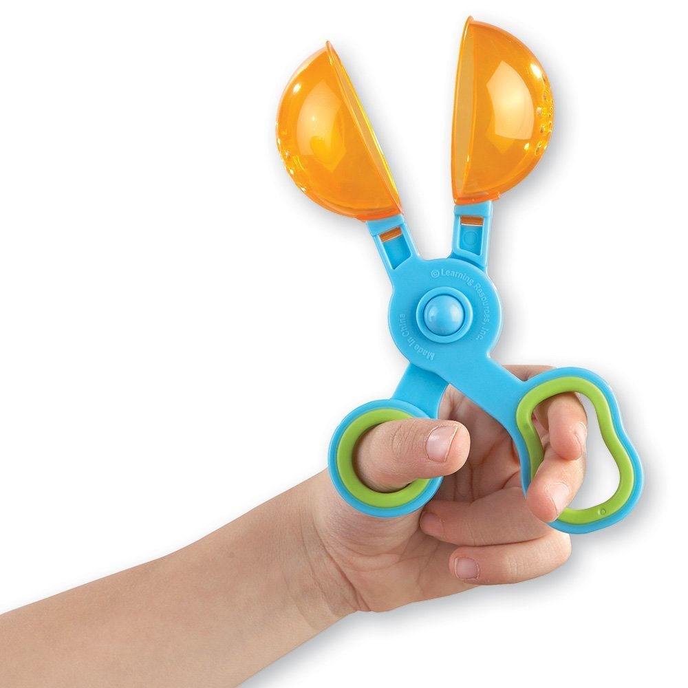 Close up of translucent Handy Scoopers showing scissor-style mechanism