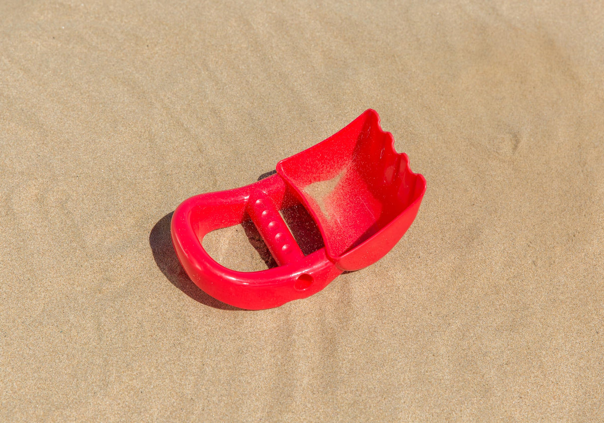 Non-toxic red sand shovel for sandbox activities
