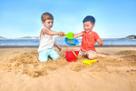 Close up of Hape sand sifter and rake for beach play