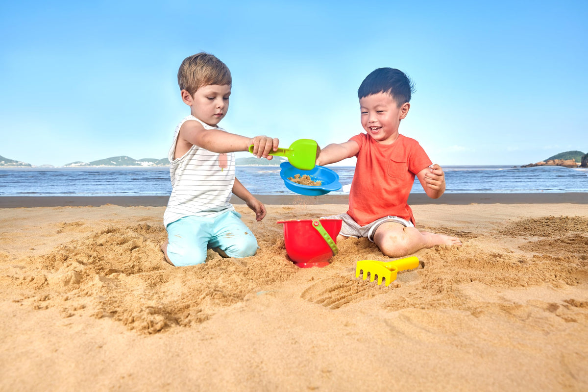 Close up of Hape sand sifter and rake for beach play