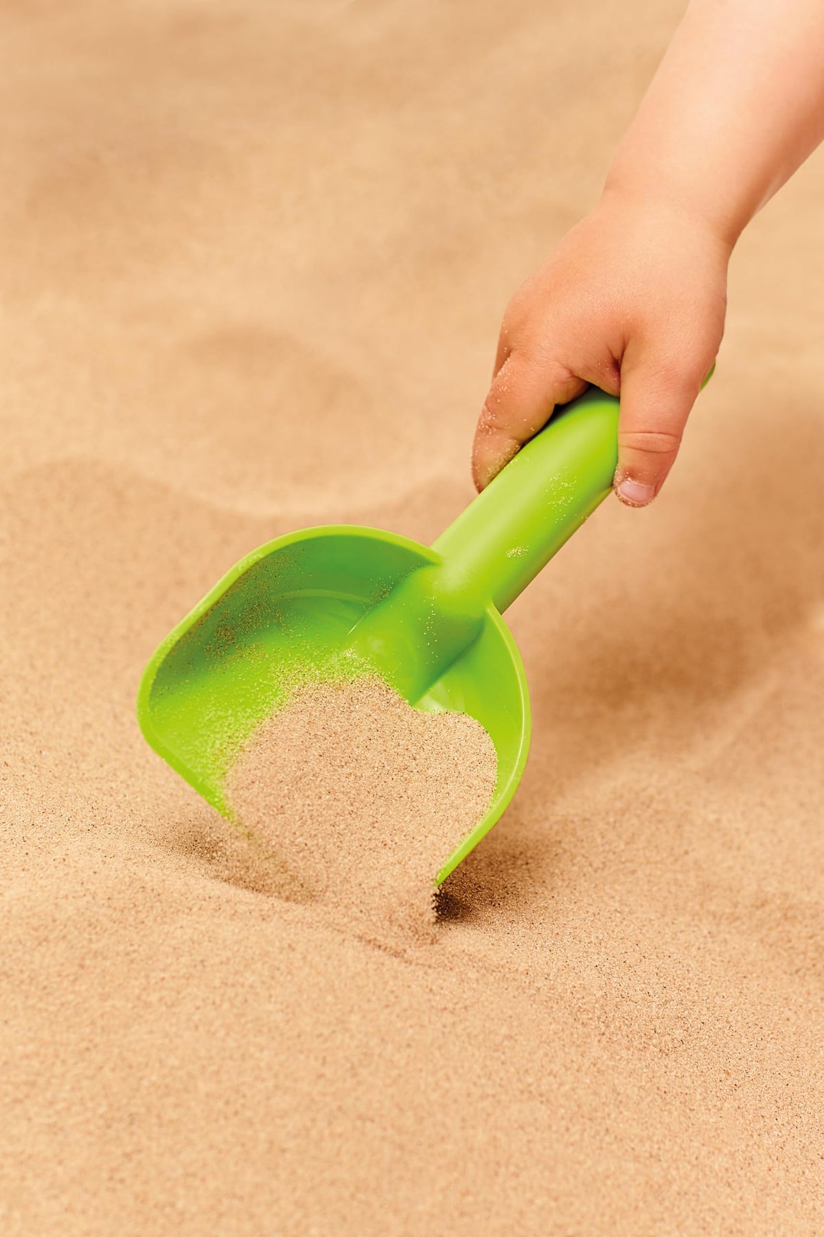 Hape beach set components arranged on sand