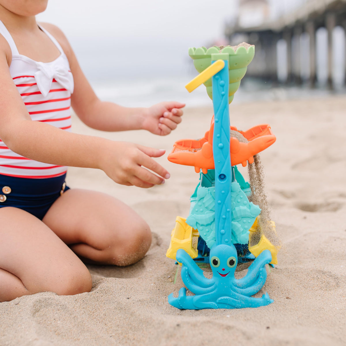 Child playing with Melissa and Doug Seaside Sidekicks at the beach