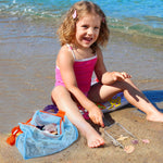 Child using Vodolo sand sifter on the beach