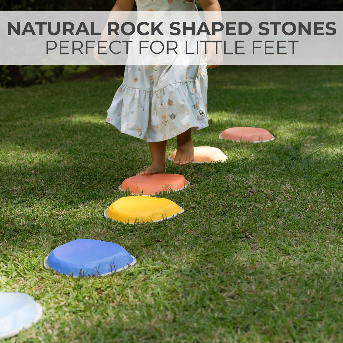 A young toddler balancing carefully on the vibrant multi colored sensory stepping stones during indoor play.