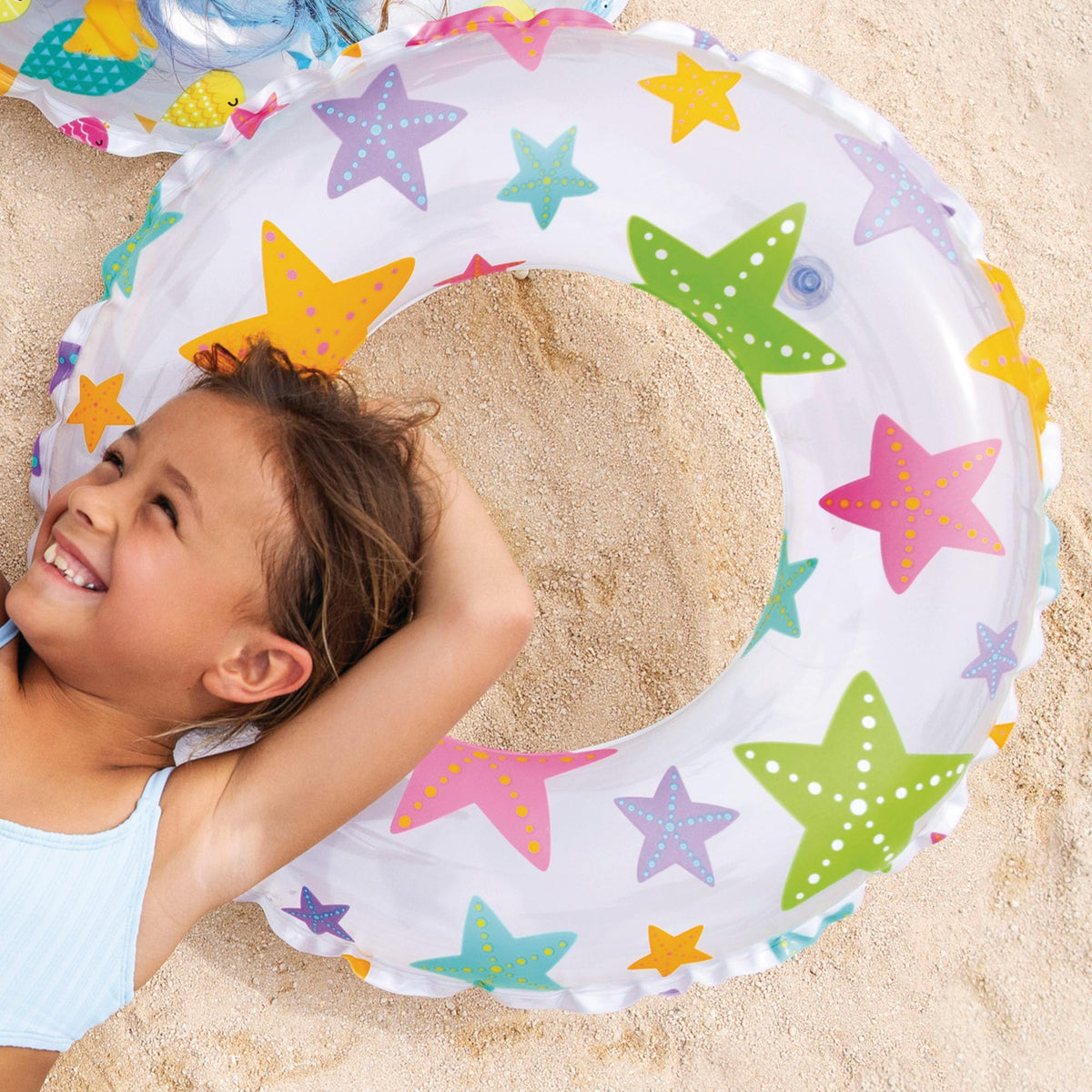 Intex inflatable toddler swimming pool set with tropical fruit print graphics on a backyard lawn