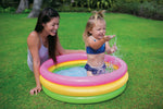 Three ring outdoor kiddie pool with pink yellow and green air chambers.