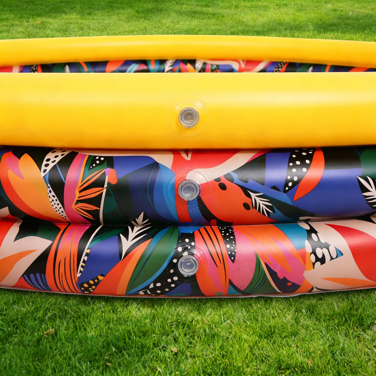 The built in quick release bottom drain plug located on the bright yellow floor of the CHICLIST outdoor play pool.