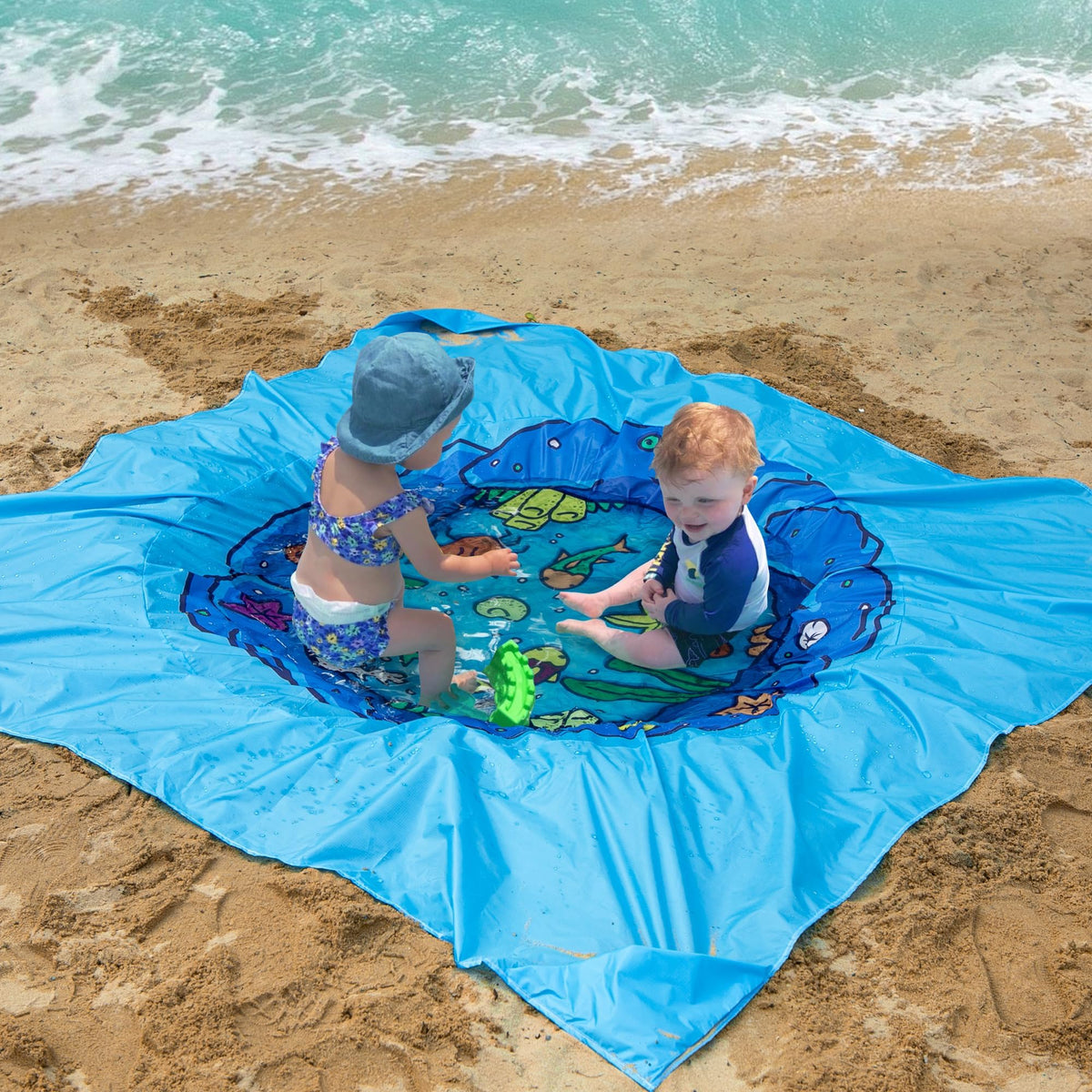 RunNico two in one beach blanket unfolded to full size on an outdoor summer family vacation.