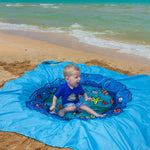 RunNico waterproof baby splash pool being folded back into its compact portable carry bag.