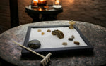 Miniature zen garden accessories including rocks and rake