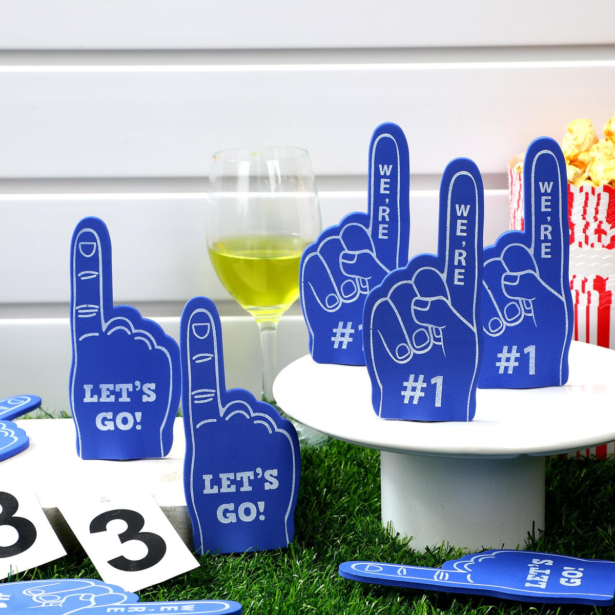 Hand wearing a mini foam finger prop