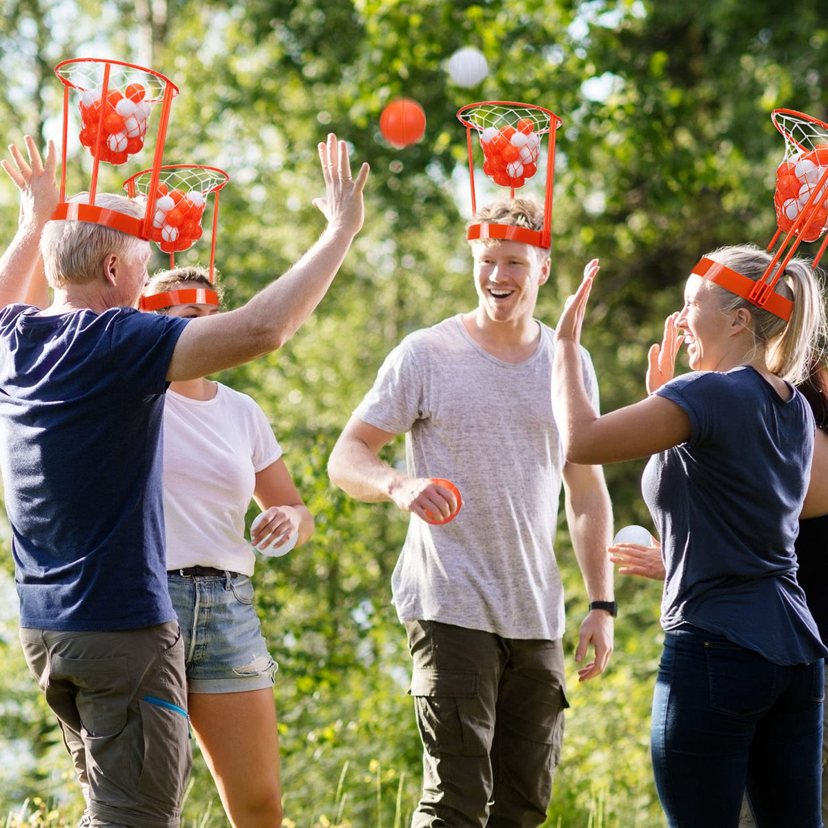 Family playing head hoop basketball during an outdoor gathering