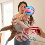 Toddler holding a 7 inch mini basketball for scale