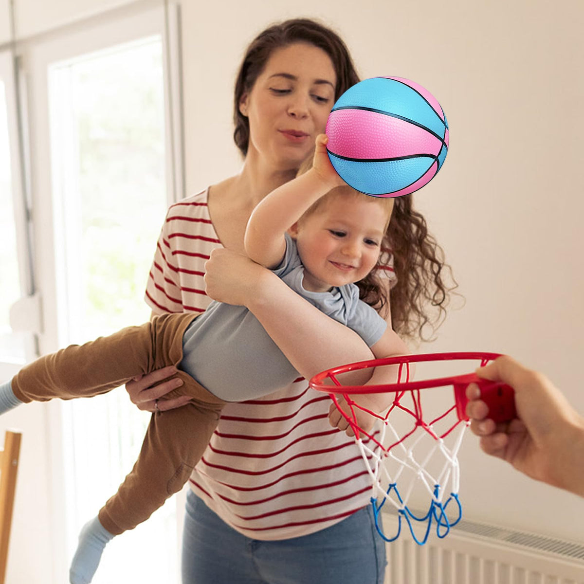 Toddler holding a 7 inch mini basketball for scale