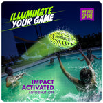 Teenagers playing catch with the impact activated light up football at the beach