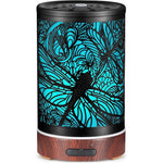 Kobodon dragonfly metal essential oil diffuser front view on wood table.