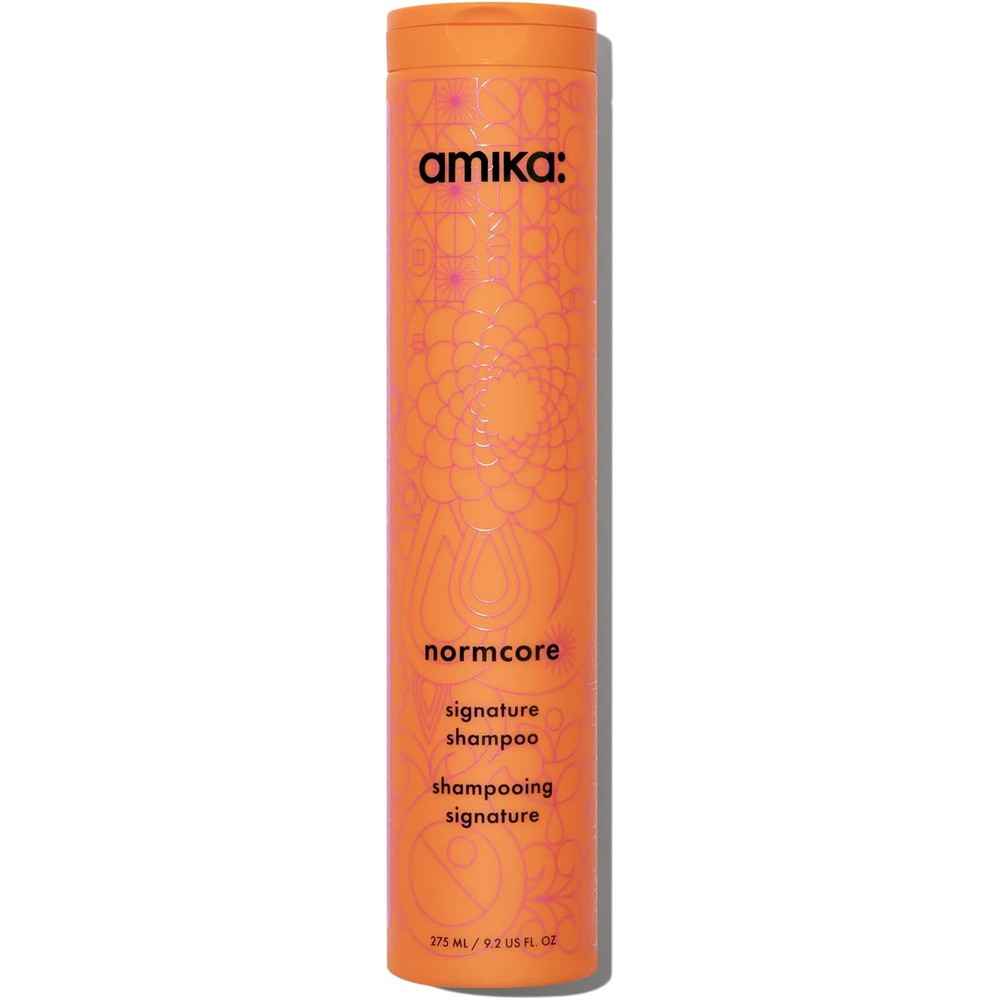 Amika Normcore Signature Shampoo front view orange bottle daily cleanser