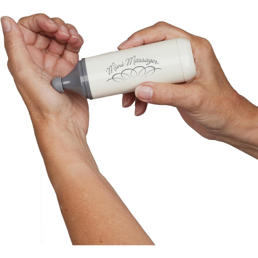 North Coast Medical Norco Mini Therapeutic Massager front view showing the compact handheld device with battery cap