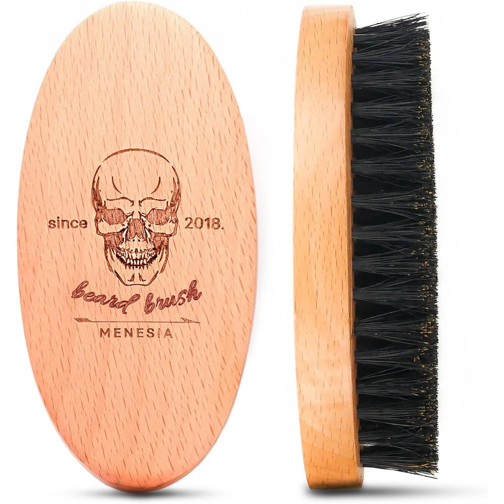 Menesia boar bristle beard brush front view showing the skull logo on the wooden handle.