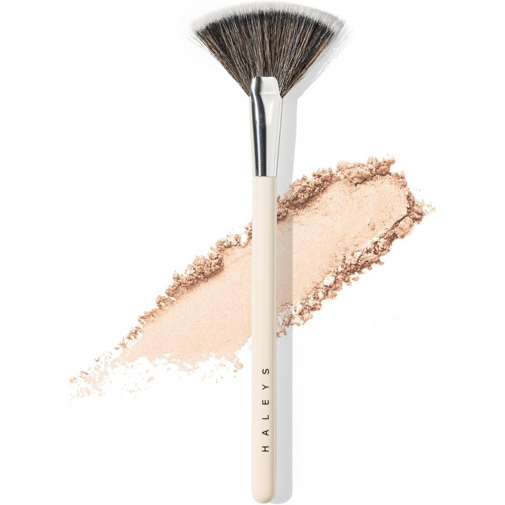 HALEYS Beauty Fan Makeup Brush front view showing soft white feathery bristles and wooden handle for highlighting powder application