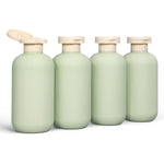 Demora travel bottles for toiletries front view showing four green squeeze containers with flip caps