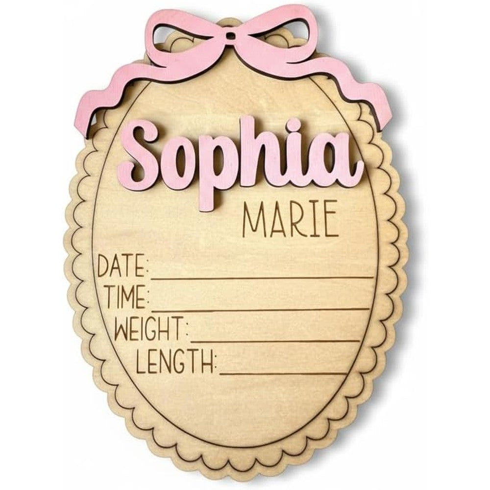 ValeriaCustomDesigns Personalized Baby Announcement Sign front view showing scalloped edge and pink bow photo prop.