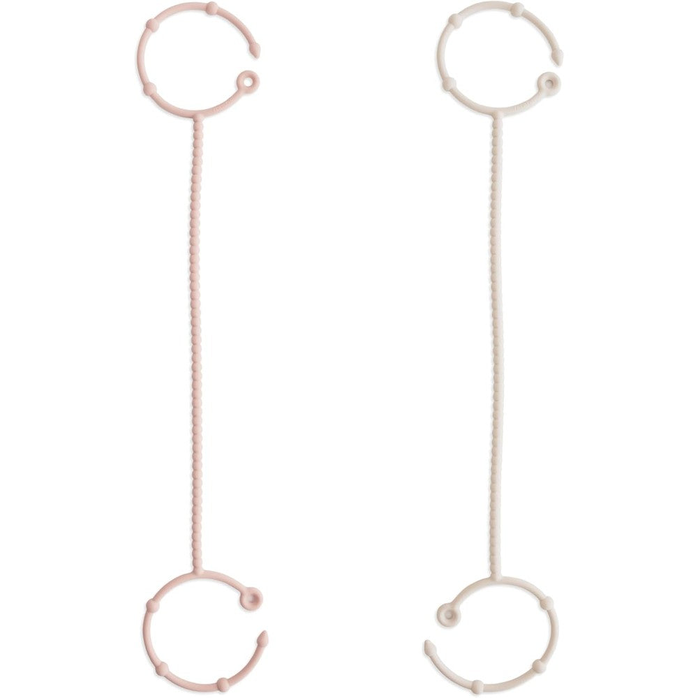 Mushie adjustable silicone toy straps 2 pack front view in packaging.