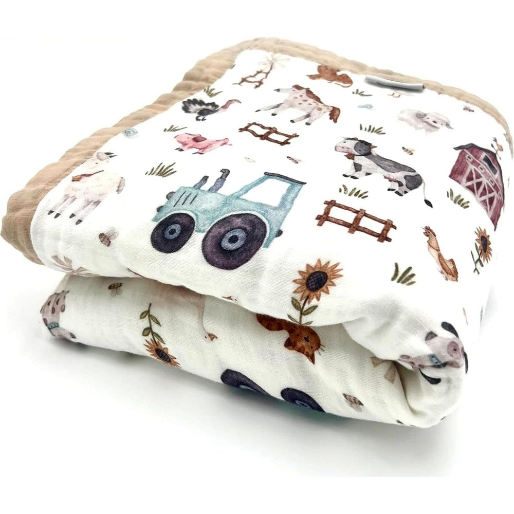 Natchiketa organic cotton muslin baby blanket front view showing farm animal and tractor print.