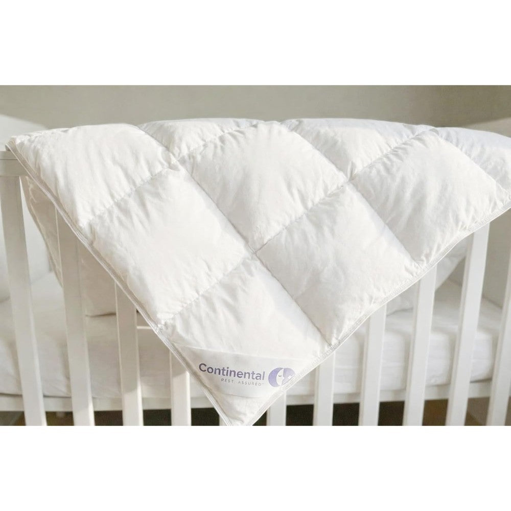 Continental Bedding Serenity toddler down comforter front view of white duvet insert on a crib