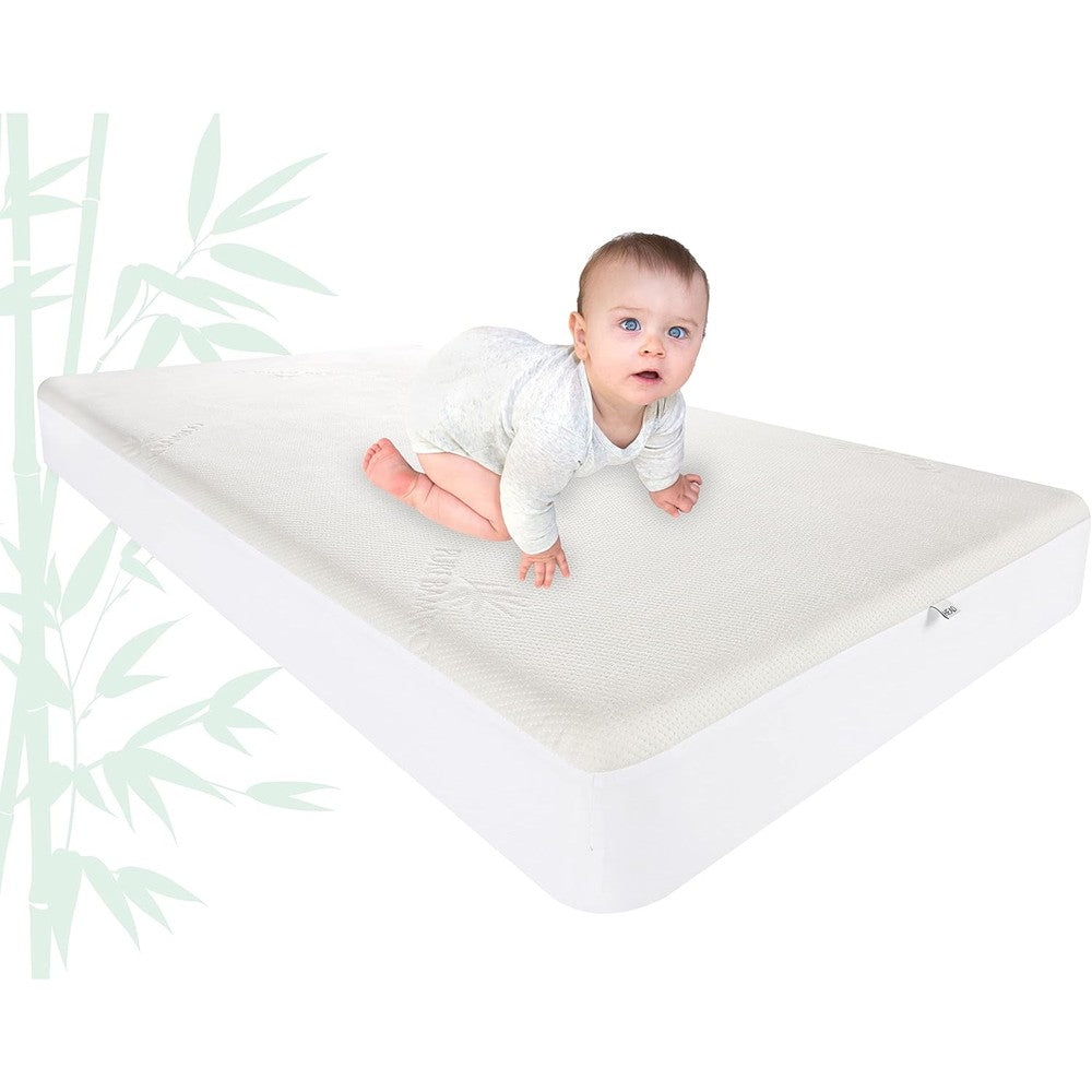 Pure Bamboo Crib Waterproof Mattress Protector front view on a standard baby bed