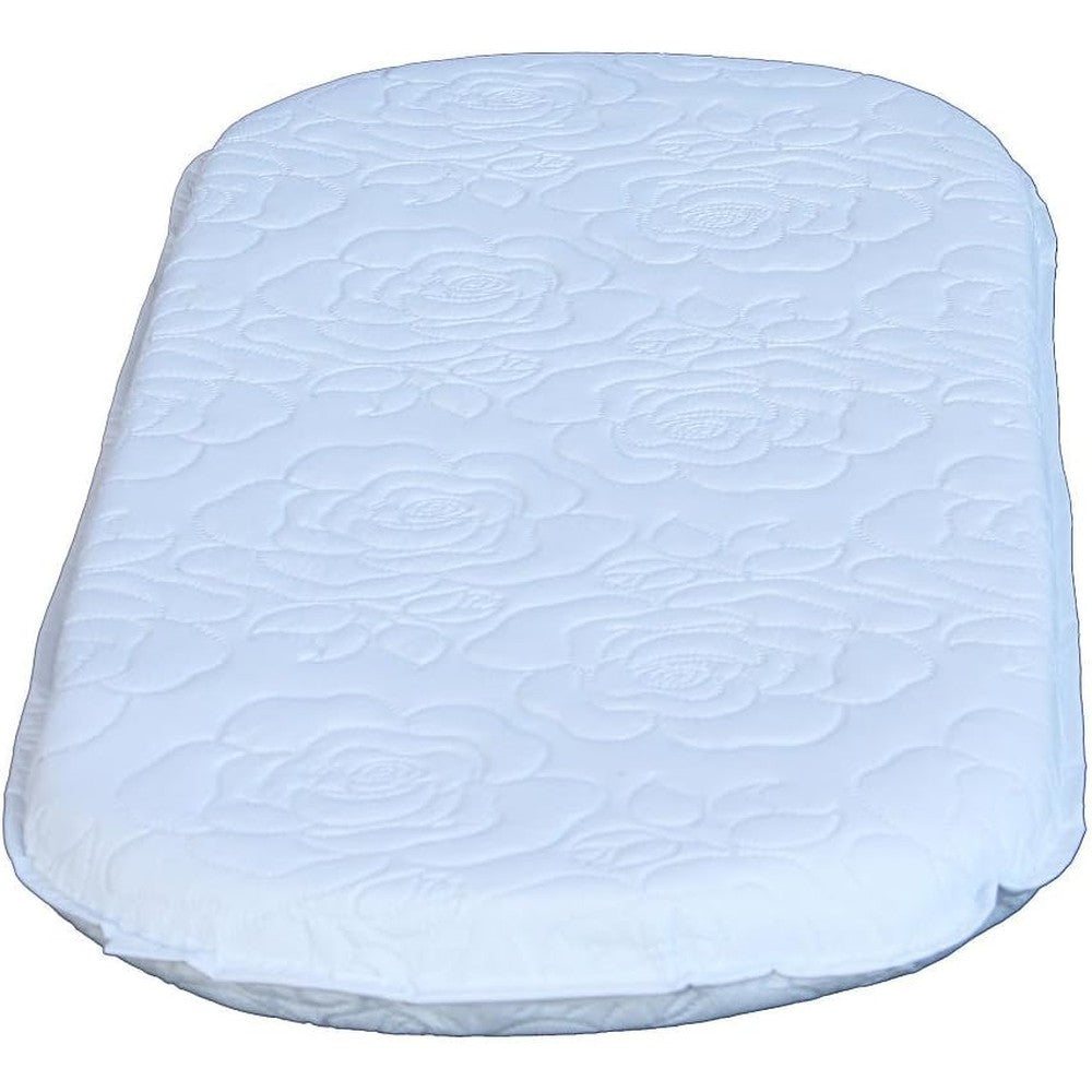 Colgate Mattress oval bassinet pad front view featuring white quilted floral pattern cover.